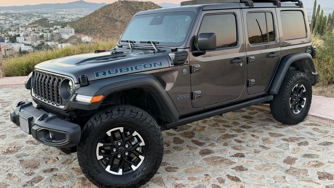 2025 Jeep Wrangler Rubicon 4xe — the plug-in hybrid model owners report losing electric power in, with the dash displaying 'Electric Mode Temporarily Unavailable' during normal driving.